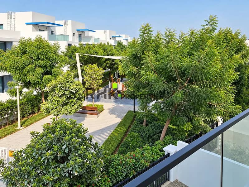 13 Landscaped community park with children's playground viewed from villa balcony in Dubai gated community