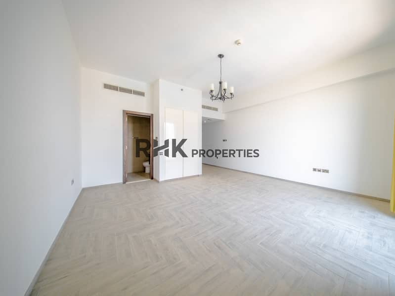 4 Large unfurnished studio apartment with open layout, built-in storage and floor-to-ceiling window