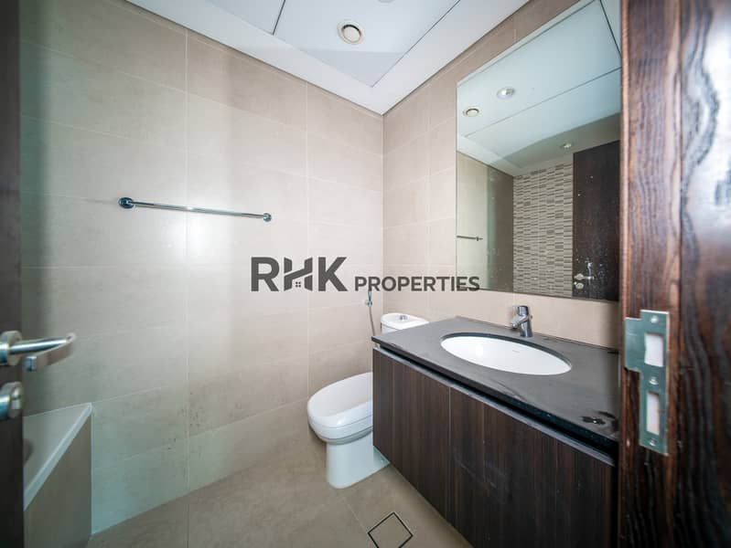6 Modern apartment bathroom with vanity sink, large mirror and contemporary tile finishes