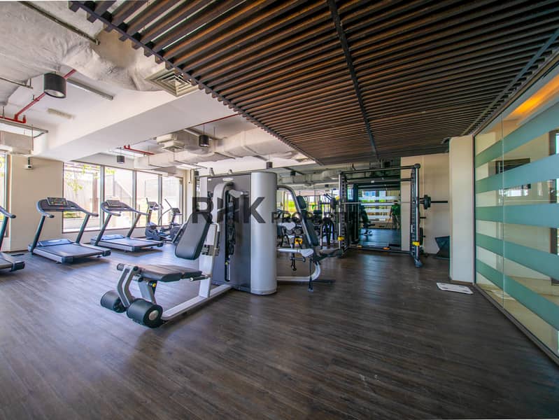 8 Fully equipped residential gym with cardio machines, strength equipment and modern workout space