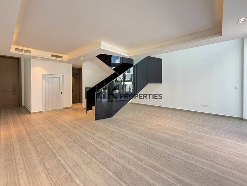 2 Contemporary townhouse living area with open-plan layout, modern staircase and recessed ceiling lighting
