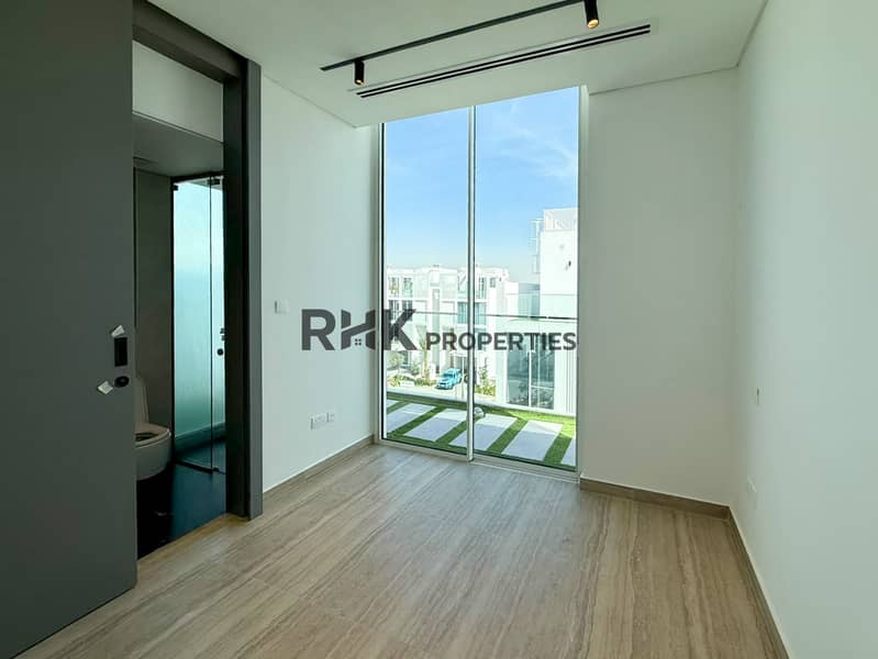 5 Bright modern townhouse bedroom with floor-to-ceiling window, contemporary lighting and garden views