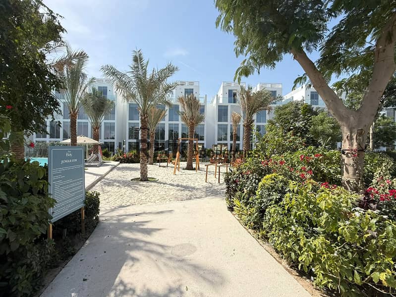 14 The Bay community outdoor jungle gym with palm trees, landscaped gardens and family recreation area