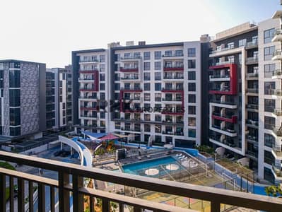 Monolocale in vendita a Arjan, Dubai - Balcony view of swimming pool, kids' play area and sports court at Floarea Residence Dubai Monolocale in vendita a Arjan, Dubai - Balcony view of swimming pool, kids' play area and sports court at Floarea Residence Dubai