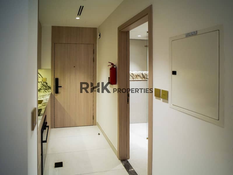 9 Studio apartment hallway leading to kitchenette and en-suite bathroom at Floarea Residence Dubai