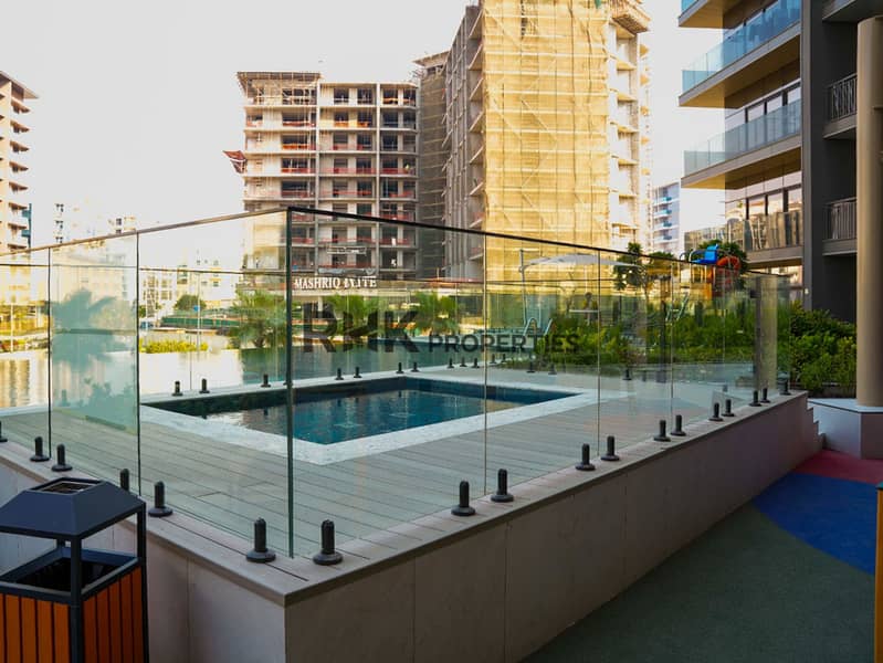 14 Children's pool with glass safety fencing beside main swimming pool at Floarea Residence Dubai