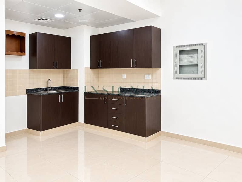 4 Empty Modern Tiled Kitchenette with Utility Panel. png