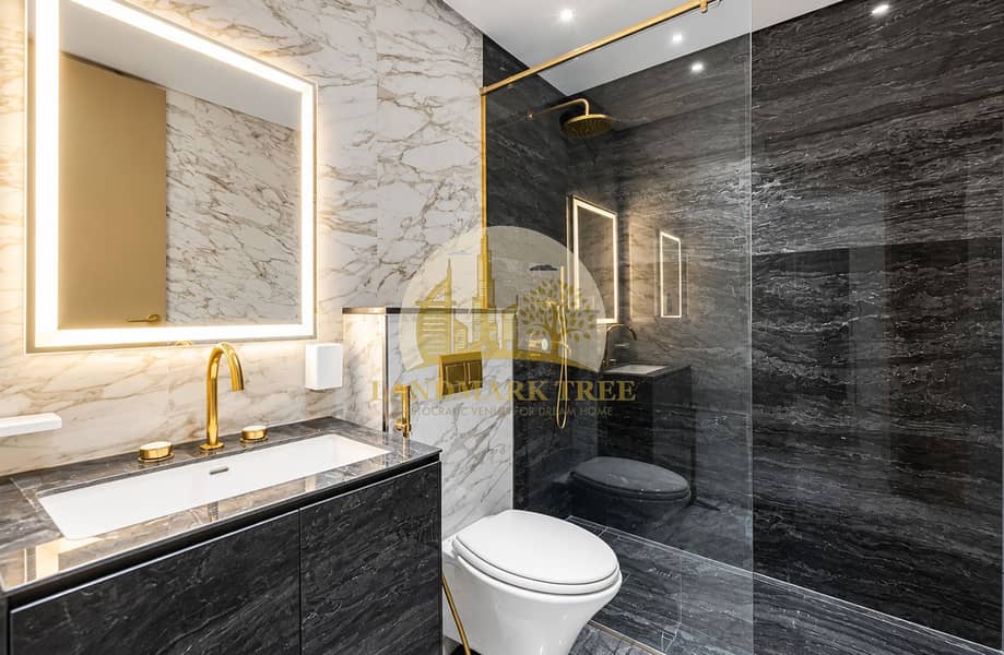 8 Luxurious Marble Bathroom with Brass Accents. png