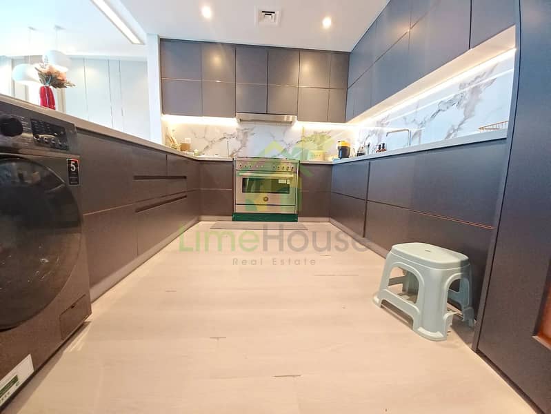 9 3-bedroom-apartment-5242-dubai-marina-kitchen-u-shaped-integrated-washer-marble-backsplash. webp