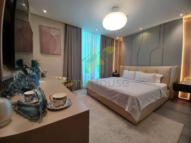11 dubai-marina-master-bedroom-upholstered-bed-modern-lighting-feature-wall. webp