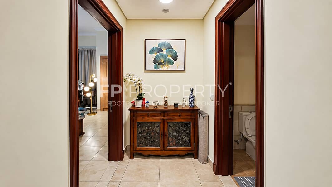 6 Warm Symmetrical Hallway with Ornate Console. png