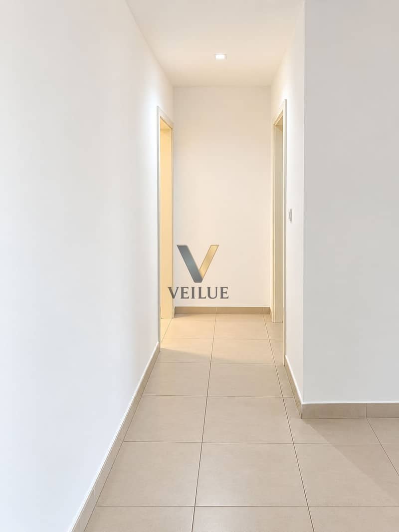 6 Minimalist White Hallway with Warm Doorways. png