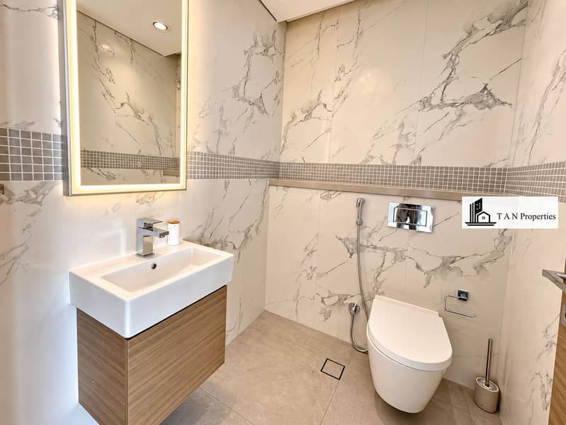 18 Modern Marble Bathroom with Warm Lighting. png