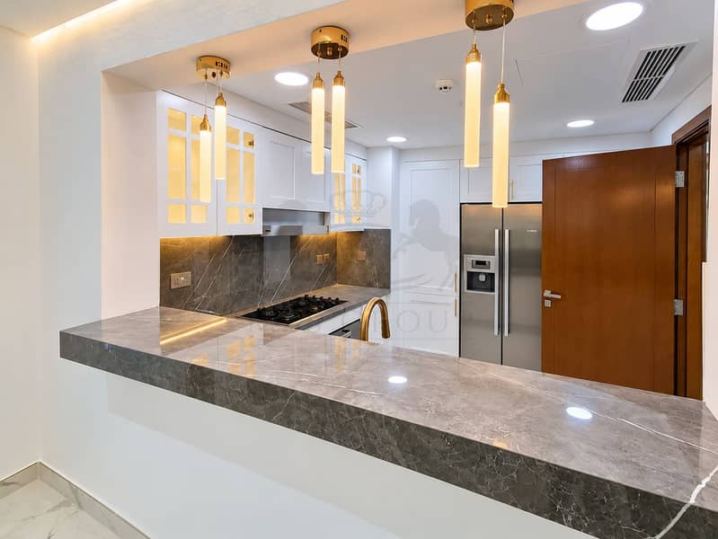 14 Warm Modern Kitchen with Marble Bar. png