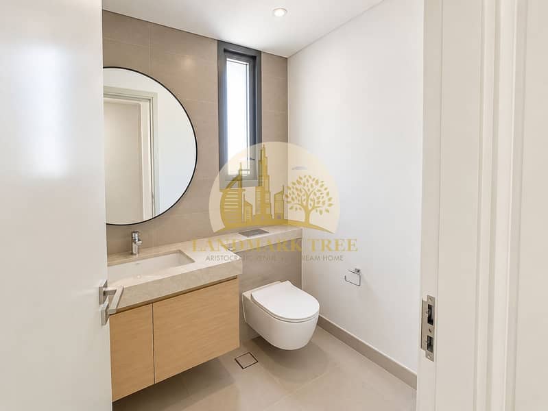 17 Minimalist Taupe Bathroom with Floating Vanity. png