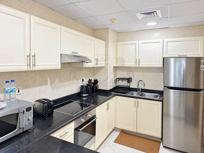 7 Bright Modern Cream Kitchen with Black Countertops. png