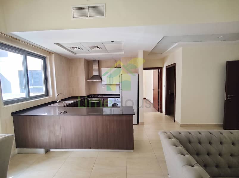 8 02-dubai-al-furjan-azizi-liatris-1-bedroom-apartment-open-plan-kitchen-living-room. jpg