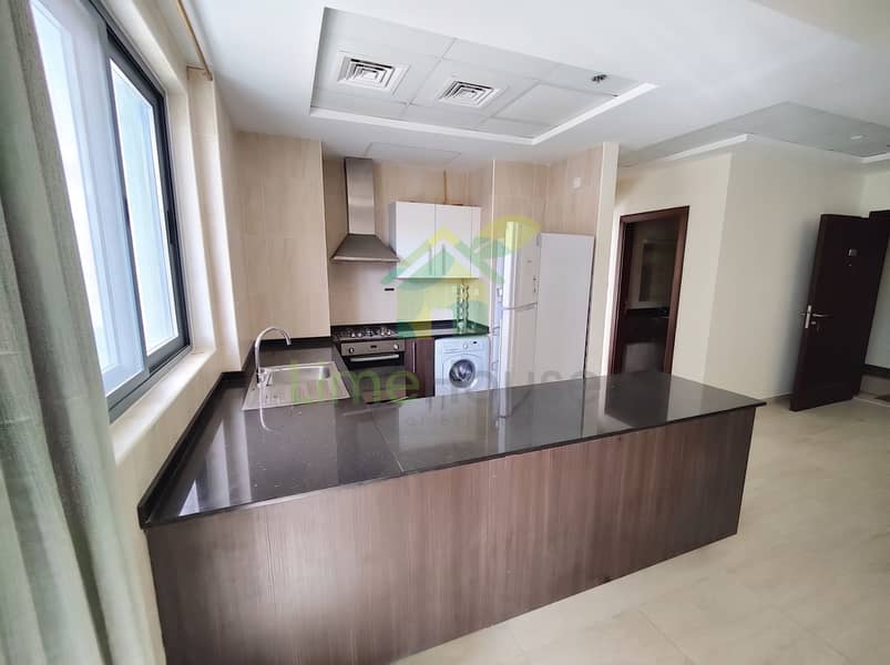 9 04-dubai-al-furjan-azizi-liatris-1-bedroom-apartment-open-plan-kitchen-island. jpg