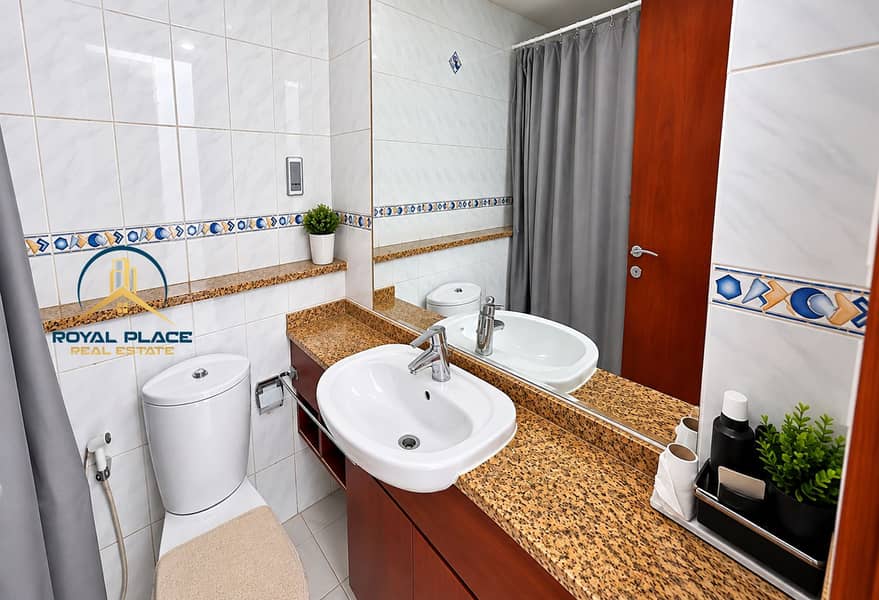 8 Modern Marble Bathroom with Blue Tile Accents. png