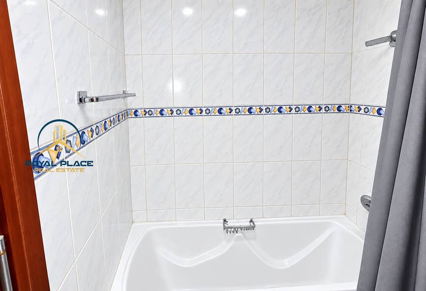 9 Bright Marble-Tiled Bathroom with Ornamental Border. png