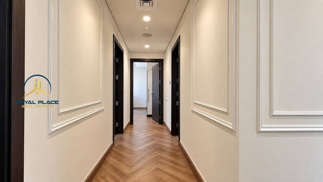 10 Symmetrical Cream Hallway with Herringbone Flooring. png