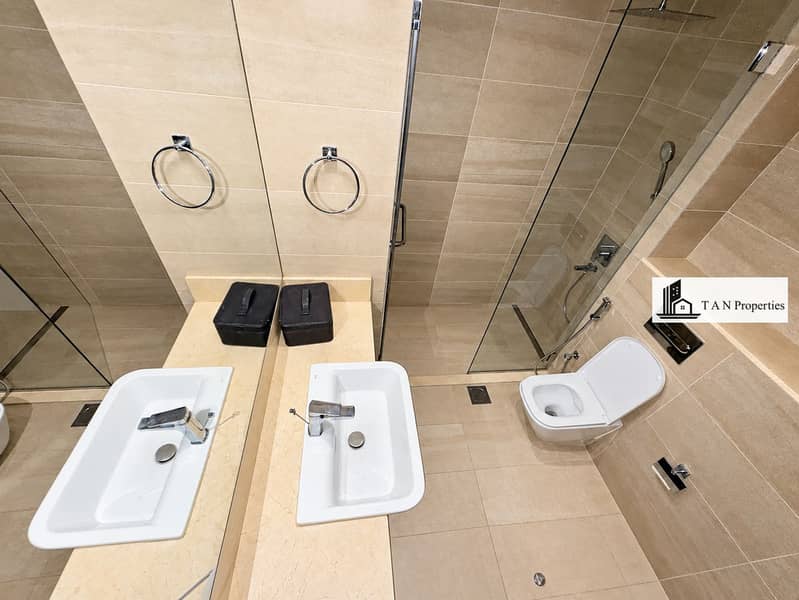 14 Modern Beige Tile Bathroom with Glass Shower. png