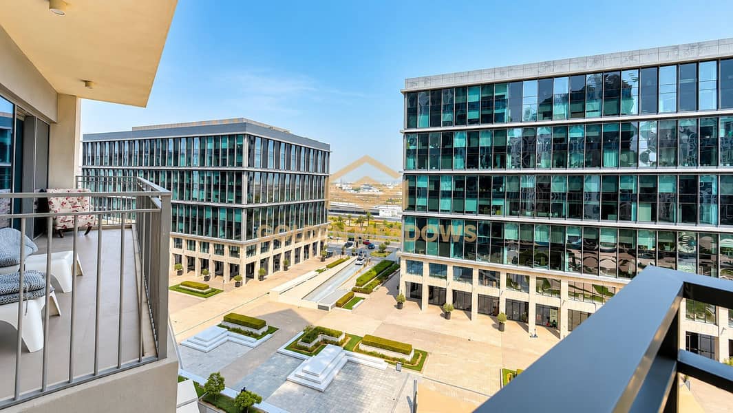 2 Sunlit Balcony Overlooking Modern Office Courtyard. png