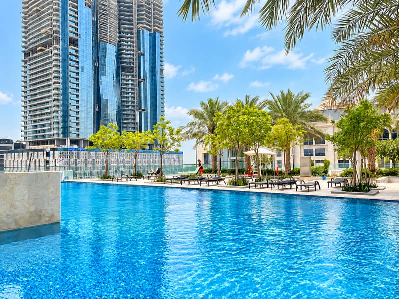 4 Refined resort pool with palms. png