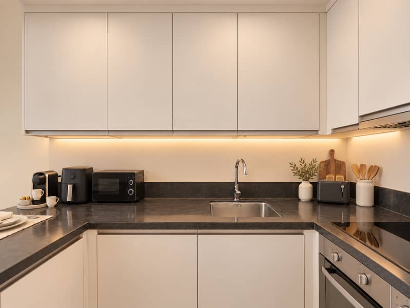8 Refined warm-ivory kitchen with charcoal accents. png