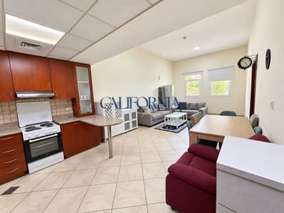 1 Bedroom Apartment for Rent in Motor City, Dubai - Bright, Tidy Kitchen-Living Interior. png