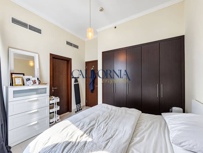 3 Bedroom with dresser and ironing board. png