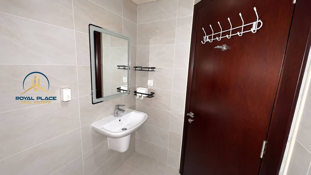 9 Modern Tiled Bathroom with Wooden Door. png