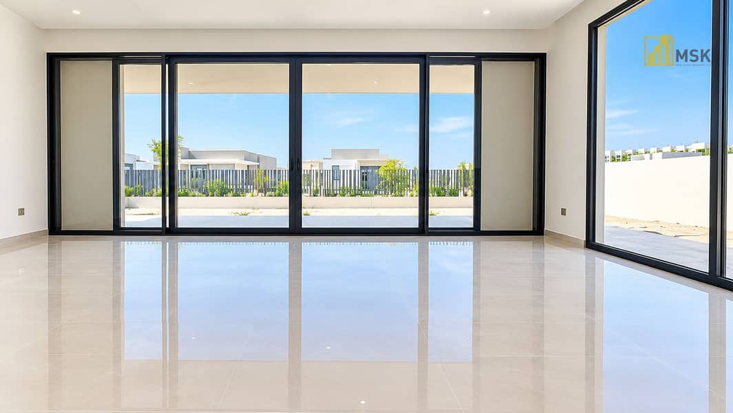 3 Bright Minimalist Room with Reflective Glass Doors. png
