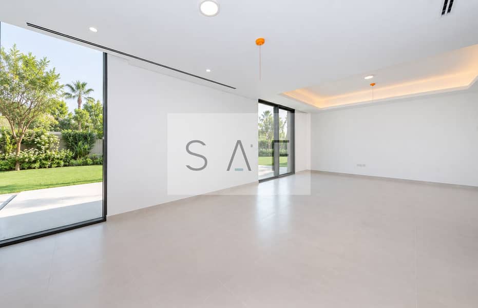 9 Bright living room overlooking lush villa garden. png