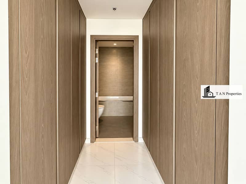 8 Modern Wood-Paneled Hallway to Bathroom. png