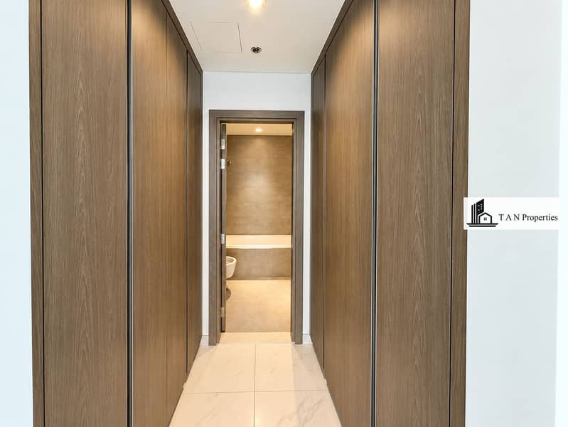 10 Symmetrical Wood-Paneled Hallway to Bathroom. png