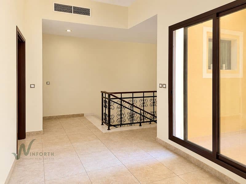 8 Minimalist Beige Hallway with Ornate Stair Railing. png