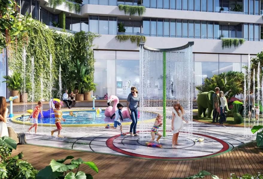 7 Family splash pad with fountains, shaded pool, and landscaped gardens at the base of the residential tower.