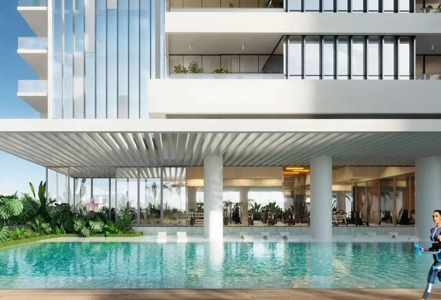 9 Ground-floor swimming pool with timber deck and lounge chairs set beneath a glass-fronted residential tower.