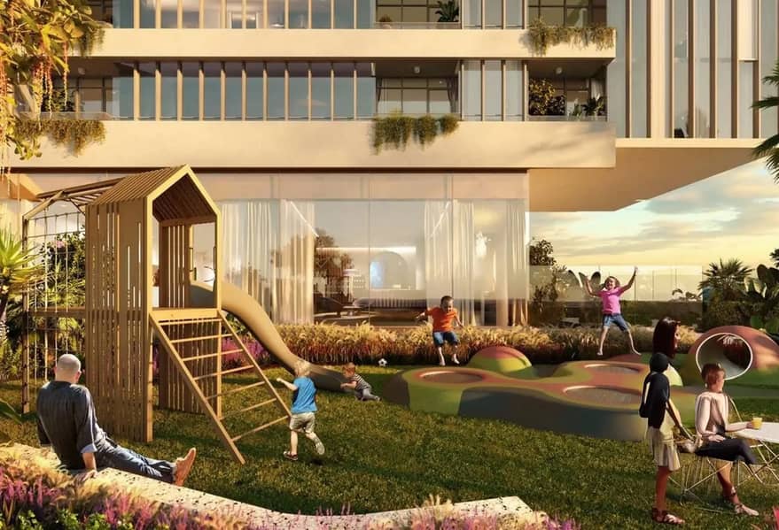 10 Children's play area with a wooden playhouse, slide, and landscaped lawn at the base of the residential tower.