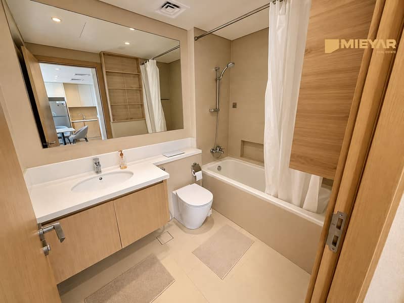 8 Warm Minimalist Bathroom with Kitchen Reflection. png