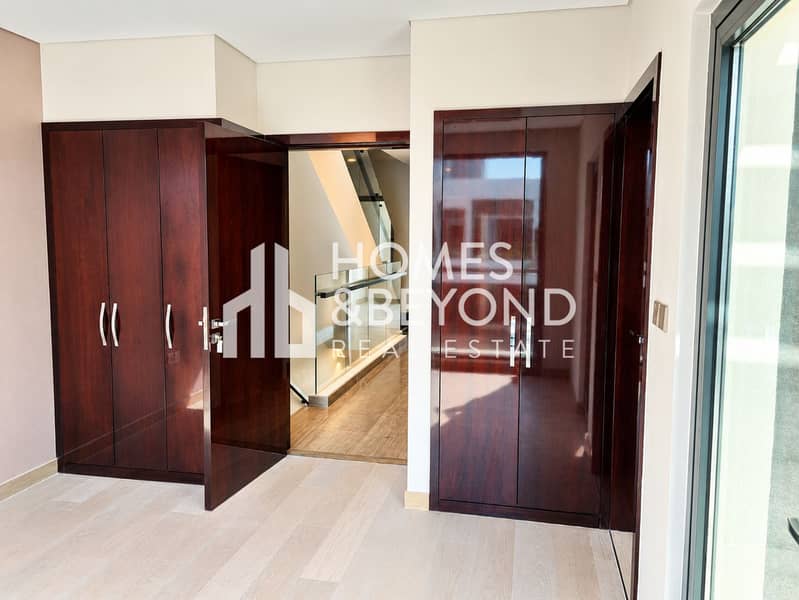 6 Modern Entryway with Glossy Wood Closets. png