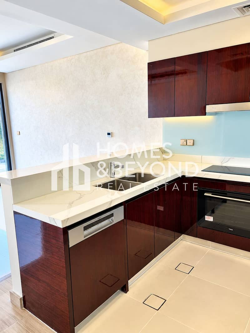 9 Modern Glossy Wood Kitchen with Marble Counters. png
