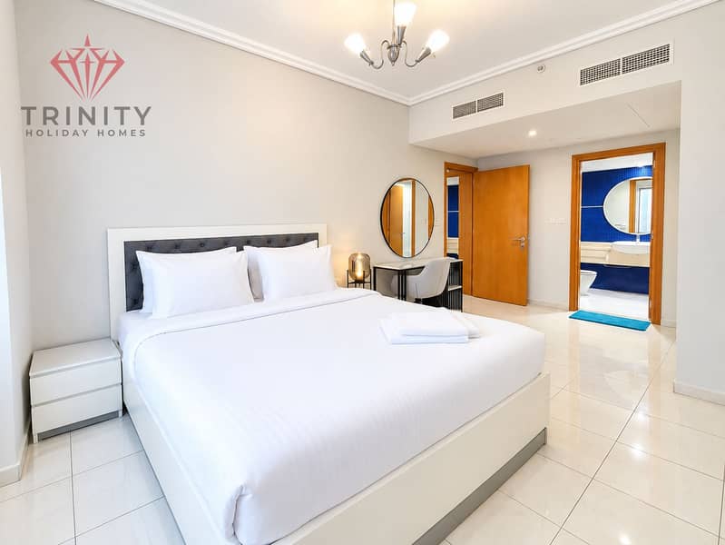 7 Modern Hotel Bedroom with Blue-Tiled Bathroom. png