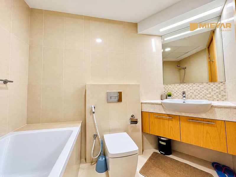 5 Modern Beige Bathroom with Warm Wood Vanity. png