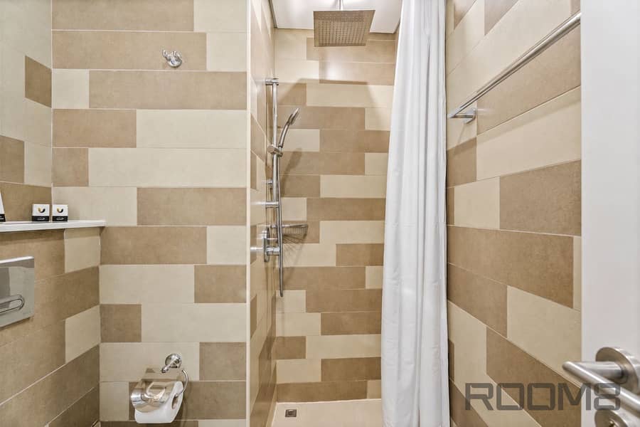 22 Minimalist Beige-Tiled Hotel Bathroom. png