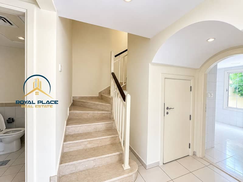 4 Bright Neutral Foyer with Marble Staircase. png