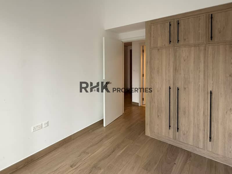 5 Spacious bedroom with fitted wardrobe and wood flooring, Town Square Dubai