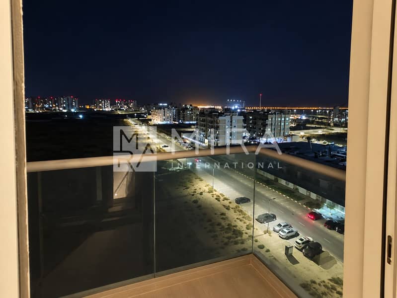 3 Neat bedroom with nighttime balcony view-9