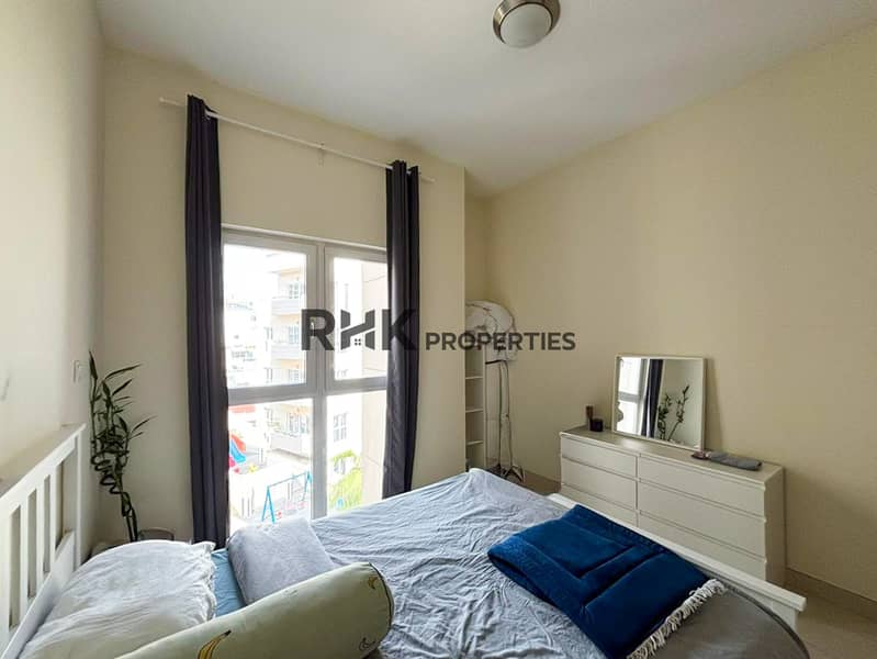 5 Bright apartment bedroom with double bed, large window, curtains and white dresser